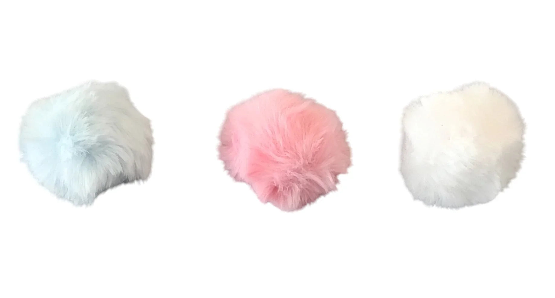 Three fluffy faux fur pompons in pastel blue, pink, and white on white background, Croch'pelotes accessory